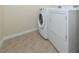 Laundry area featuring tiled floors and modern white washer and dryer units at 11649 Tempest Harbor Loop, Venice, FL 34292