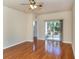 Bright living room boasts wood floors and sliding glass doors to a screened lanai at 11649 Tempest Harbor Loop, Venice, FL 34292