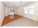 Living room featuring wood flooring, tile flooring, a ceiling fan, and sliding glass doors to the lanai at 11649 Tempest Harbor Loop, Venice, FL 34292
