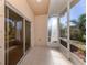 View of a screened lanai with tiled floor and sliding glass door entry at 11649 Tempest Harbor Loop, Venice, FL 34292