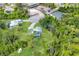 An aerial view of the property displays the home with a pool and lush surroundings in a quiet neighborhood at 1214 Rumson Ct, North Port, FL 34288
