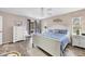 A well-lit main bedroom features light walls, wood-look floors, and sliding glass doors at 1214 Rumson Ct, North Port, FL 34288