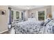 A large bedroom features natural lighting from three windows, light walls, and wood-look floors at 1214 Rumson Ct, North Port, FL 34288