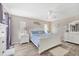 Bright bedroom featuring wood floors, ceiling fan, and white furniture at 1214 Rumson Ct, North Port, FL 34288