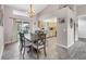 An open dining room with a chandelier has tile floors and is open to the kitchen with a breakfast bar at 1214 Rumson Ct, North Port, FL 34288