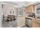 This dining room is open to the kitchen and has a vaulted ceiling, tile floors, and sliding glass doors at 1214 Rumson Ct, North Port, FL 34288
