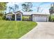 Charming one-story home featuring a well-maintained lawn, inviting entrance and attached two car garage at 1214 Rumson Ct, North Port, FL 34288