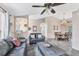 Open-concept living room flows into the dining area with hardwood floors, vaulted ceilings, and natural light at 1214 Rumson Ct, North Port, FL 34288