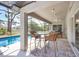 The screened-in patio has wicker chairs, a ceiling fan, tile floors, and a view of the pool at 1214 Rumson Ct, North Port, FL 34288