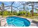 Pool area with a screened enclosure and lounge chairs at 1214 Rumson Ct, North Port, FL 34288