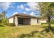 Charming home featuring a well-maintained backyard with a screen porch and lush landscaping at 12370 Canavese Ln, Venice, FL 34293