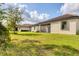 Spacious backyard features lush green grass and a screened patio for relaxing at 12370 Canavese Ln, Venice, FL 34293