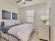 Inviting bedroom with plush bedding, tile floors, and lots of natural light at 12370 Canavese Ln, Venice, FL 34293