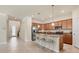 Open kitchen with stainless steel appliances, a center island, and breakfast bar seating at 12370 Canavese Ln, Venice, FL 34293