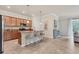 Spacious kitchen featuring wooden cabinetry, granite counters, and a center island with seating at 12370 Canavese Ln, Venice, FL 34293