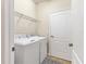 Convenient laundry room equipped with a washer, dryer, and shelving for storage at 12370 Canavese Ln, Venice, FL 34293