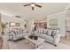 Spacious living room area featuring tile floors, stylish furniture, and an inviting ambiance at 12370 Canavese Ln, Venice, FL 34293