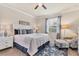 Comfortable bedroom featuring a ceiling fan, natural light, and coastal decor at 12370 Canavese Ln, Venice, FL 34293
