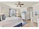 Bright bedroom with coastal decor, a ceiling fan, and a cozy reading nook at 12370 Canavese Ln, Venice, FL 34293
