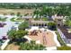 Aerial view of the community playground, featuring shade and various play structures amidst palm trees at 12370 Canavese Ln, Venice, FL 34293
