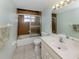 This bathroom features a white vanity, toilet and shower with tile surround at 1240 Lucaya Ave, Venice, FL 34285