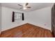 This bedroom features hardwood floors, ceiling fan and a window at 1240 Lucaya Ave, Venice, FL 34285