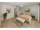 Staged bedroom with ensuite bathroom, modern paintings, furniture and a slider glass door to the patio at 1240 Lucaya Ave, Venice, FL 34285
