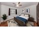 This bedroom features a ceiling fan and hardwood floors at 1240 Lucaya Ave, Venice, FL 34285