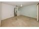 Empty bedroom with ensuite bathroom, neutral carpet, and a slider glass door to the patio at 1240 Lucaya Ave, Venice, FL 34285