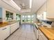 Bright kitchen features white appliances, butcher block countertops, and a picturesque view at 1240 Lucaya Ave, Venice, FL 34285