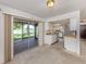 Open living room flows into the kitchen and offers sliding glass doors with a view of the outdoors at 1240 Lucaya Ave, Venice, FL 34285