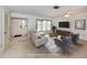Bright living room features neutral walls, front door view, and is virtually staged with stylish furniture and decor at 1240 Lucaya Ave, Venice, FL 34285