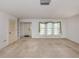 Bright living room with carpet floors, a window and a front door that offers easy access at 1240 Lucaya Ave, Venice, FL 34285