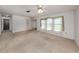 Spacious living room with neutral walls and large window, perfect for entertaining and relaxation at 1240 Lucaya Ave, Venice, FL 34285