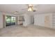 Open living room flows into kitchen and offers sliding glass doors with a view of the lush outdoors at 1240 Lucaya Ave, Venice, FL 34285