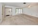 Bright living room with neutral walls and front door view, offering a blank canvas for personalization at 1240 Lucaya Ave, Venice, FL 34285