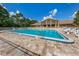 Community pool surrounded by lounge chairs and well maintained brick patio at 1240 Lucaya Ave, Venice, FL 34285