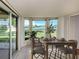 Dining room with furniture set, bay windows, and glass slider with lake view at 1240 Lucaya Ave, Venice, FL 34285