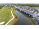Panoramic aerial view of the condo community with lush golf course, tranquil ponds, and pristine landscaping at 12440 Wellen Golf St # 204, Venice, FL 34293