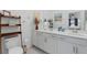 Bathroom featuring double sinks, white cabinets, and decorative accents at 12440 Wellen Golf St # 204, Venice, FL 34293