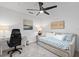 This bedroom has a ceiling fan, a desk area, day bed with blue paisley pattern at 12440 Wellen Golf St # 204, Venice, FL 34293