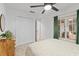 Bedroom featuring a ceiling fan, dresser, large closet, and a view from the window at 12440 Wellen Golf St # 204, Venice, FL 34293