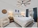 Bright bedroom with a ceiling fan, white walls, and balcony access at 12440 Wellen Golf St # 204, Venice, FL 34293