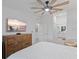 This bedroom includes a ceiling fan and a view into the bathroom at 12440 Wellen Golf St # 204, Venice, FL 34293