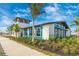 Side view of the clubhouse, showcasing a blend of textures and colors, with a beautifully landscaped garden at 12440 Wellen Golf St # 204, Venice, FL 34293