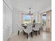 Sunlit dining room features modern chandelier, a wood table and seating for four at 12440 Wellen Golf St # 204, Venice, FL 34293