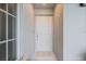 Clean and welcoming entryway with a modern door, neutral tones, and a textured mat at 12440 Wellen Golf St # 204, Venice, FL 34293