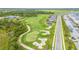 Scenic aerial view of the lush golf course, showcasing manicured greens, sand traps, and beautiful landscaping at 12440 Wellen Golf St # 204, Venice, FL 34293