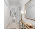 Bright hallway leads to the living areas, featuring tiled floors and stylish decor at 12440 Wellen Golf St # 204, Venice, FL 34293