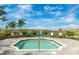 Community hot tub offers accessible seating and a tranquil view, framed by lush landscaping and a serene lake at 12440 Wellen Golf St # 204, Venice, FL 34293
